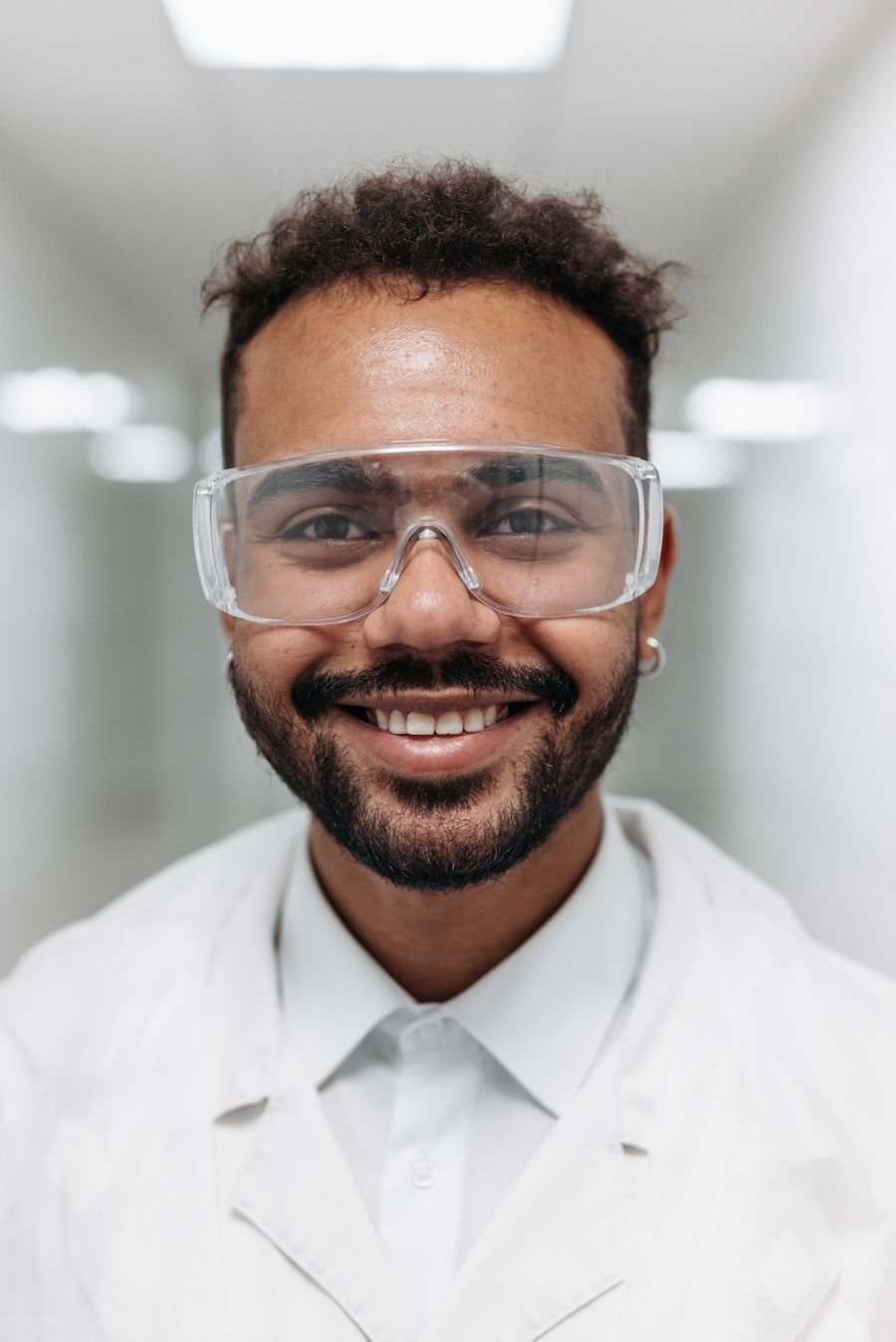 A healthcare coordinator smiling at their workstation.