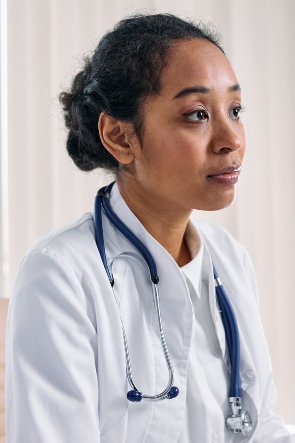 Portrait of a woman in medical scrubs.